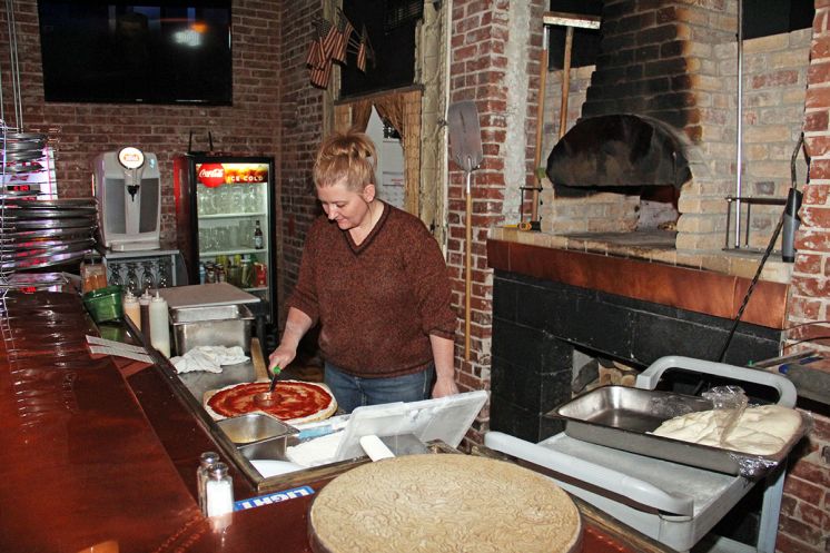 Twisted Turtle Pub owner Tosha Fuller makes a pizza for a customer as the pub achieves it’s first year in business.